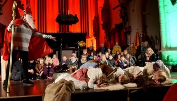 Das Foto zeigt eine Gruppe Kinder, die beim Nikolauskonzert 2024 in der Basilika St. Cyriakus auftreten.