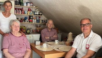 Das Foto zeigt vier Menschen an einem Tisch.