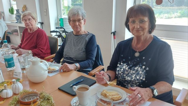 Drei ältere Frauen essen Kuchen